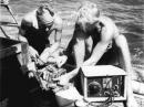 Knut Haugland and Torstein Raaby aboard the Kon-Tiki, working with the LI2B radio gear. [Courtesy of the Kon-Tiki Museum]